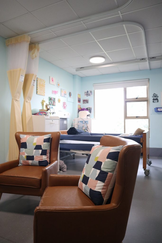 A light blue room with two leather armchairs.